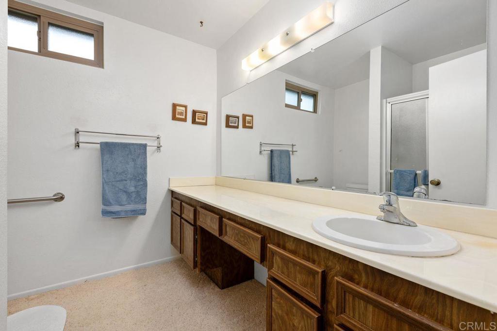 727 Nob Circle Vista, CA 92084 - Photo 24 of 39 a bathroom with a sink and a mirror