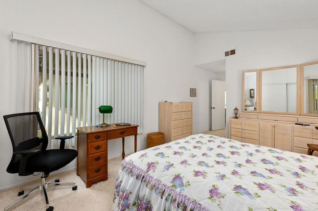 727 Nob Circle Vista, CA 92084 - Photo 27 of 39 a bedroom with a bed and a chair