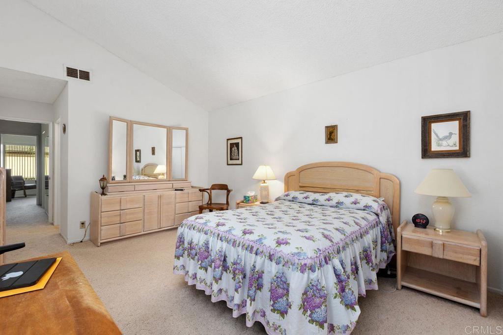 727 Nob Circle Vista, CA 92084 - Photo 28 of 39 a spacious bedroom with a bed and a dresser