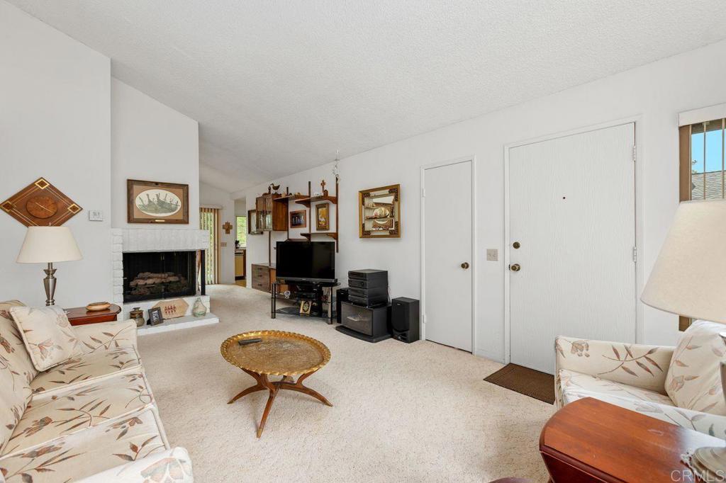 727 Nob Circle Vista, CA 92084 - Photo 6 of 39 a living room with furniture a rug and a fireplace