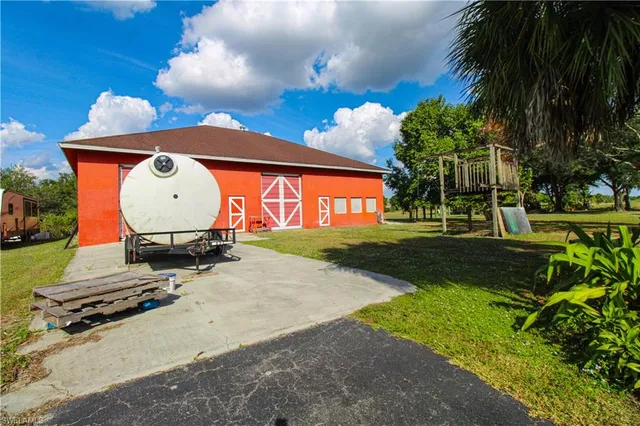 a view of a house with a yard and garage
