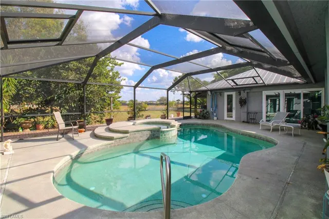 a view of a patio with dining table and chairs