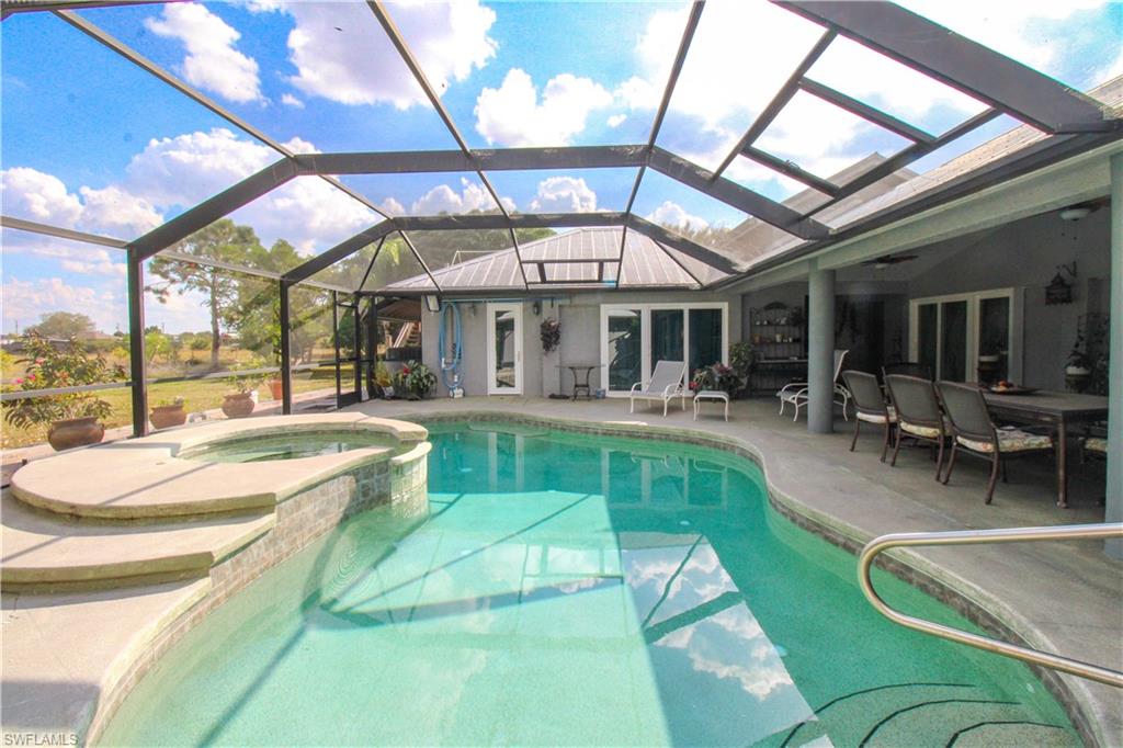 3935 70th Avenue Northeast Naples, FL 34120 - Photo 28 of 50 a view of a patio with dining table and chairs