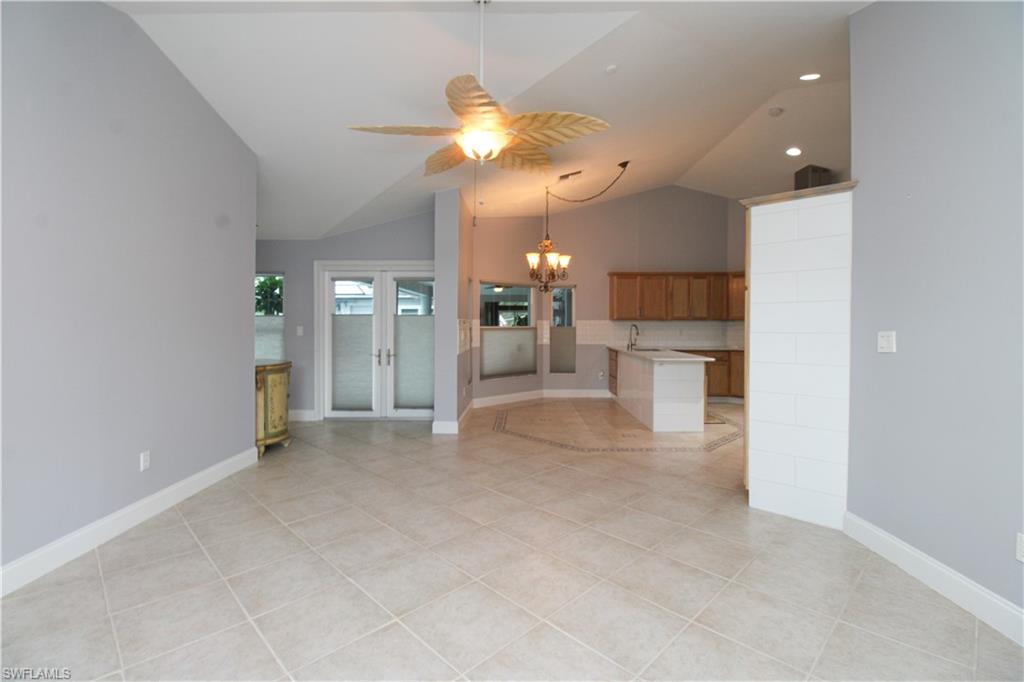 3935 70th Avenue Northeast Naples, FL 34120 - Photo 31 of 50 an empty room with a kitchen and a chandelier fan