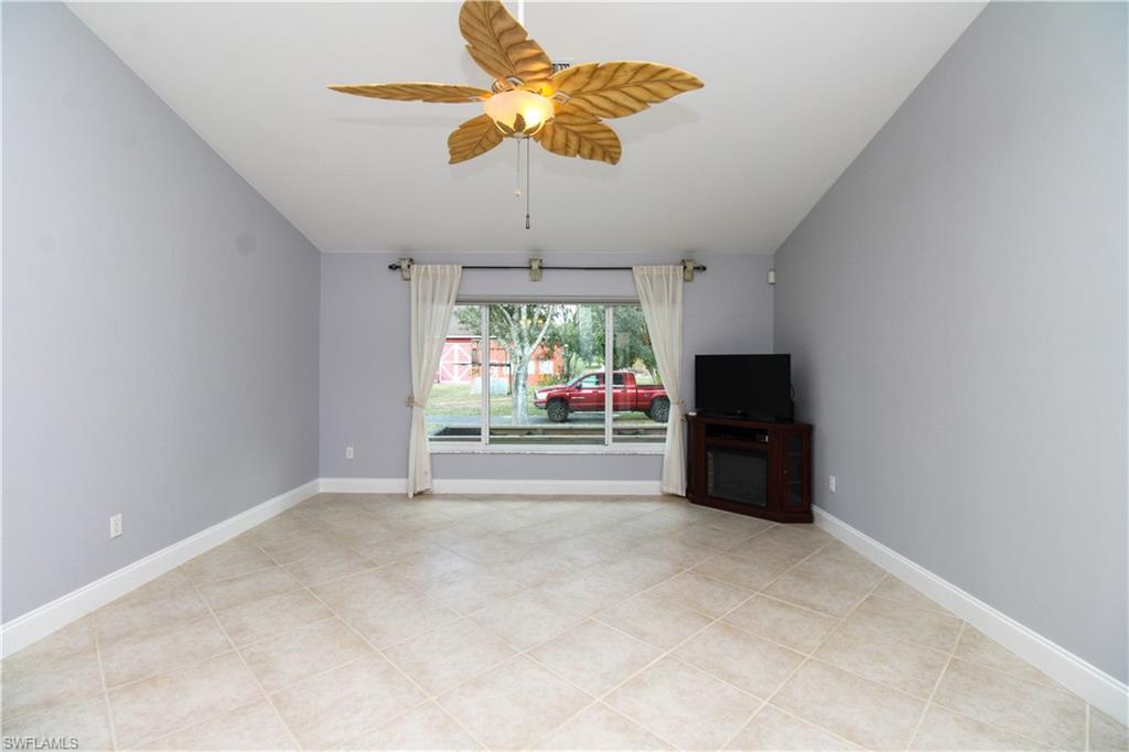 3935 70th Avenue Northeast Naples, FL 34120 - Photo 33 of 50 a room with chandelier fan and windows