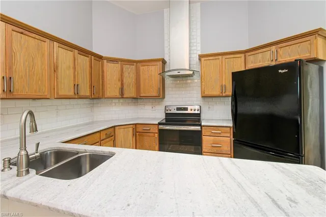 a kitchen with cabinets and refrigerator