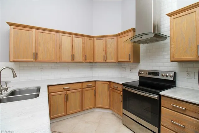 a kitchen with stainless steel appliances granite countertop a sink stove and cabinets