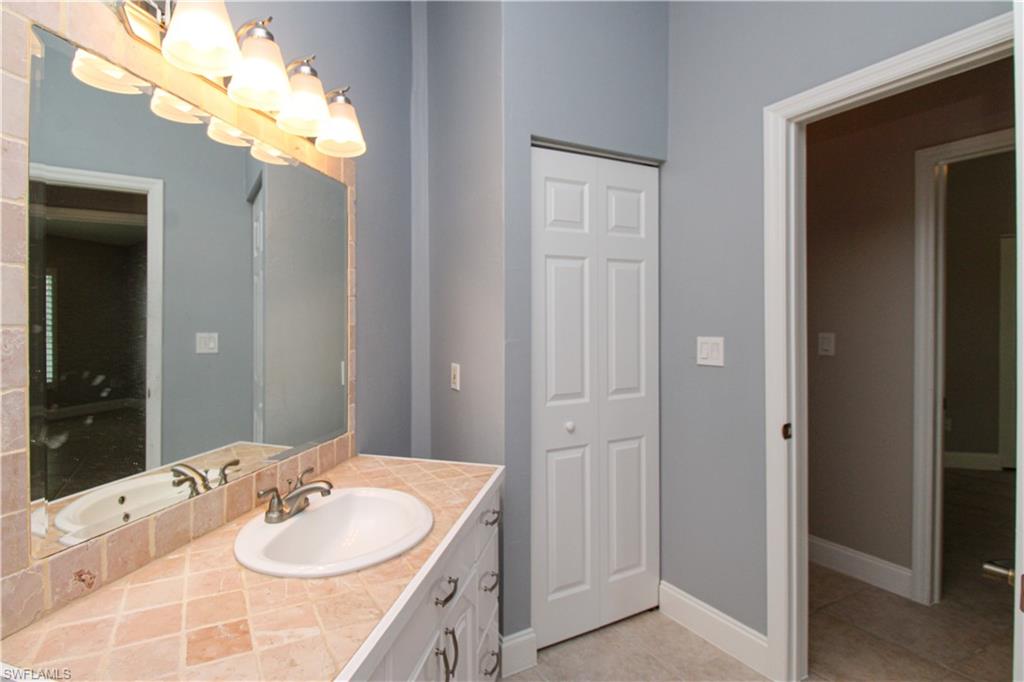 3935 70th Avenue Northeast Naples, FL 34120 - Photo 42 of 50 a bathroom with a sink vanity granite and a mirror