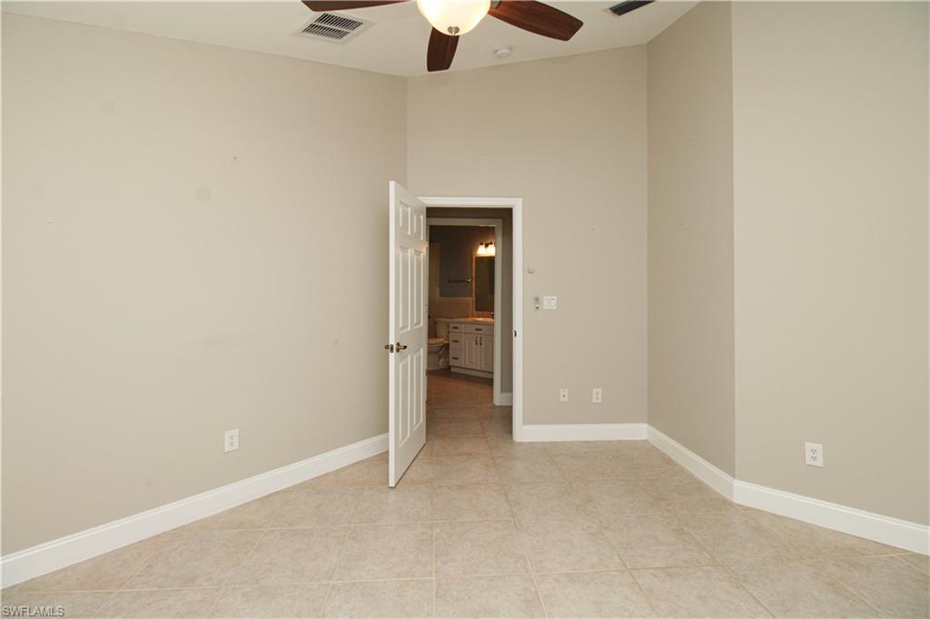 3935 70th Avenue Northeast Naples, FL 34120 - Photo 46 of 50 an empty room with a ceiling fan and carpet
