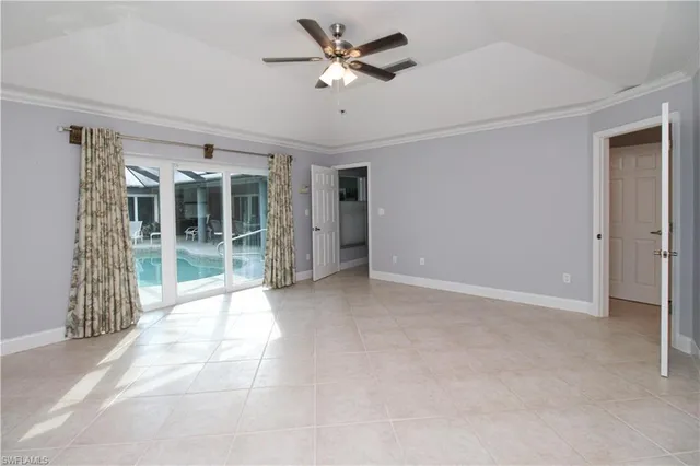 an empty room with a ceiling fan and a window