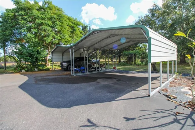 a view of a house with a yard and potted plants