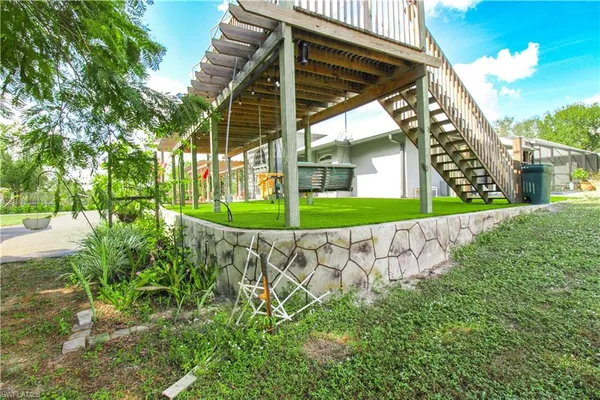 a front view of house with a garden