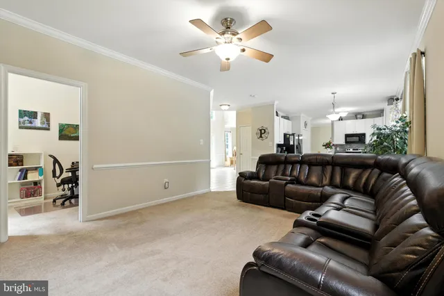 a living room with furniture and a chandelier