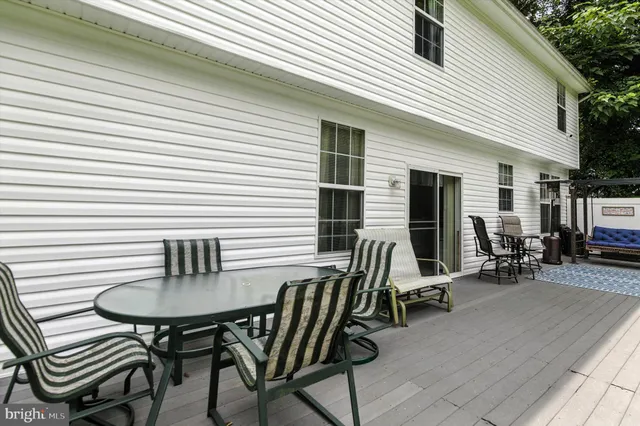a view of a patio with table and chairs and couches