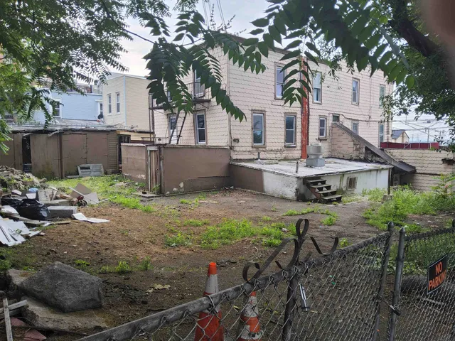 a view of a house with a yard and sitting area