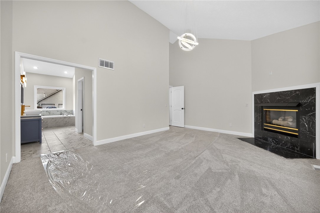 811 Wind Bluff Point Springboro, OH 45066 - Photo 17 of 51 This primary bedroom features a vaulted ceiling, cozy fireplace, and an adjoining bathroom.