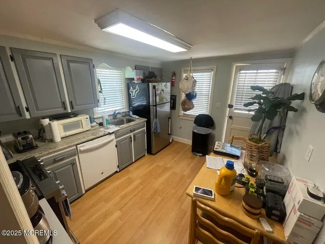 a room with furniture a flat screen tv and a sink