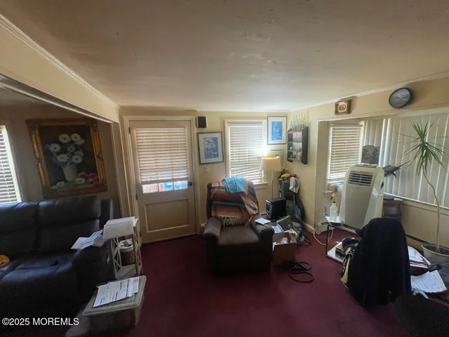 a living room with furniture windows and a flat screen tv