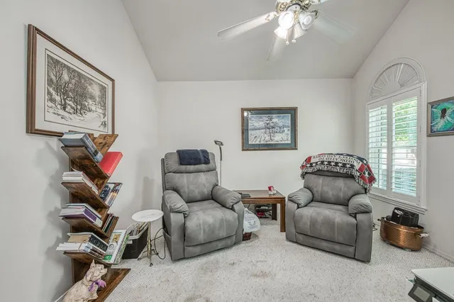 a living room with a couch and a bookshelf