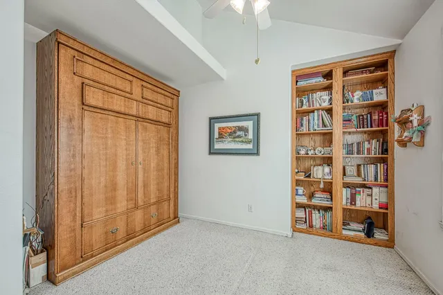 a bathroom with a granite countertop sink and a bathtub