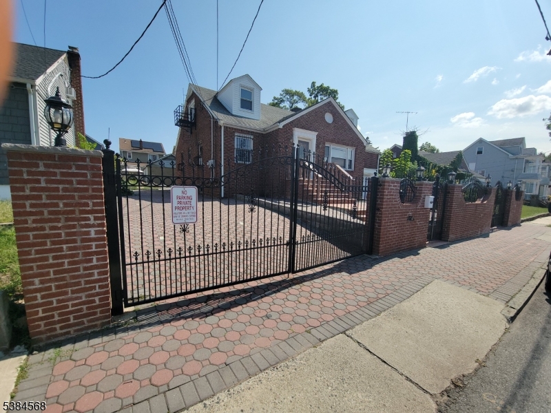 20 Greene Terrace Irvington, NJ 07111 - Photo 14 of 21 a view of a house with a small yard and wooden fence