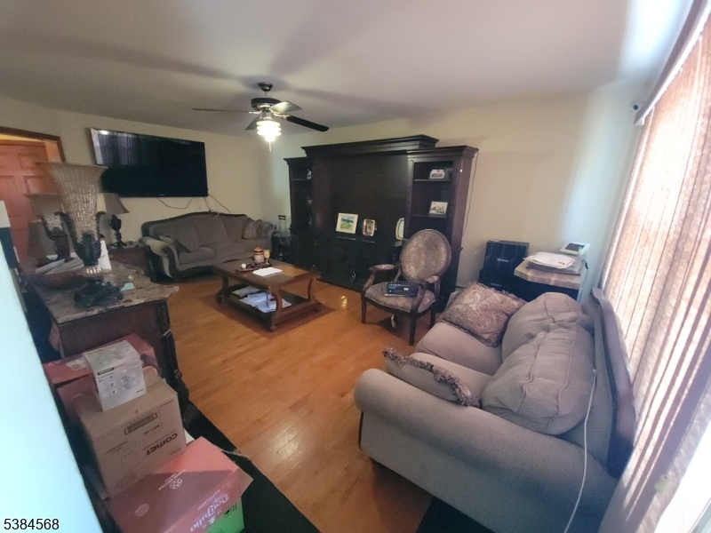 20 Greene Terrace Irvington, NJ 07111 - Photo 18 of 21 a living room with furniture a flat screen tv and a large window