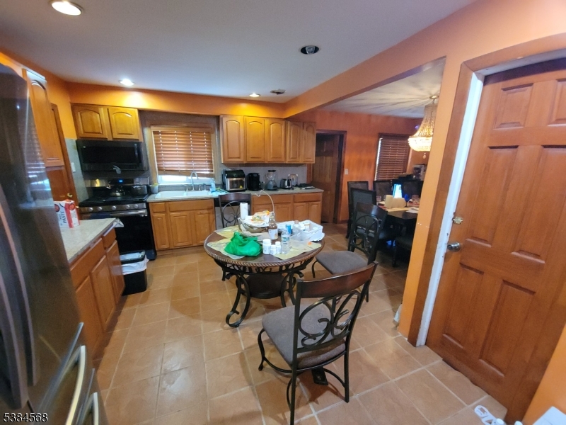 20 Greene Terrace Irvington, NJ 07111 - Photo 19 of 21 a dining room with furniture and a flat screen tv