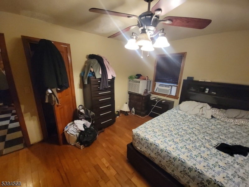 20 Greene Terrace Irvington, NJ 07111 - Photo 5 of 21 a bedroom with a bed dresser and wooden floor