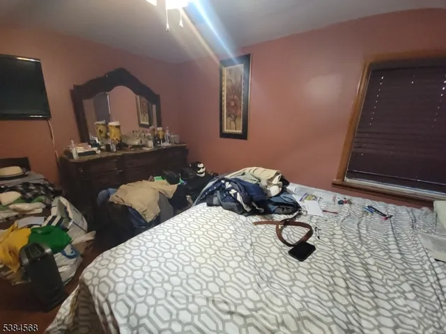 a bedroom with two beds and painting on the wall