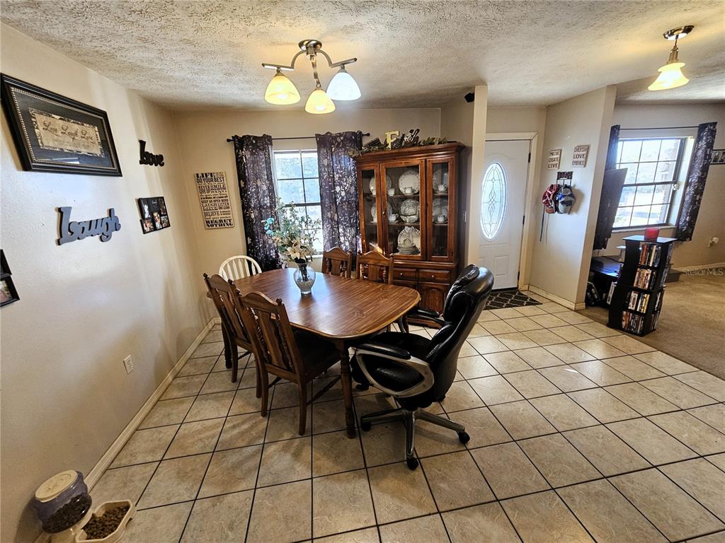 13308 Duck Lake Canal Road Dade City, FL 33525 - Photo 11 of 90 a view of a dining room with furniture