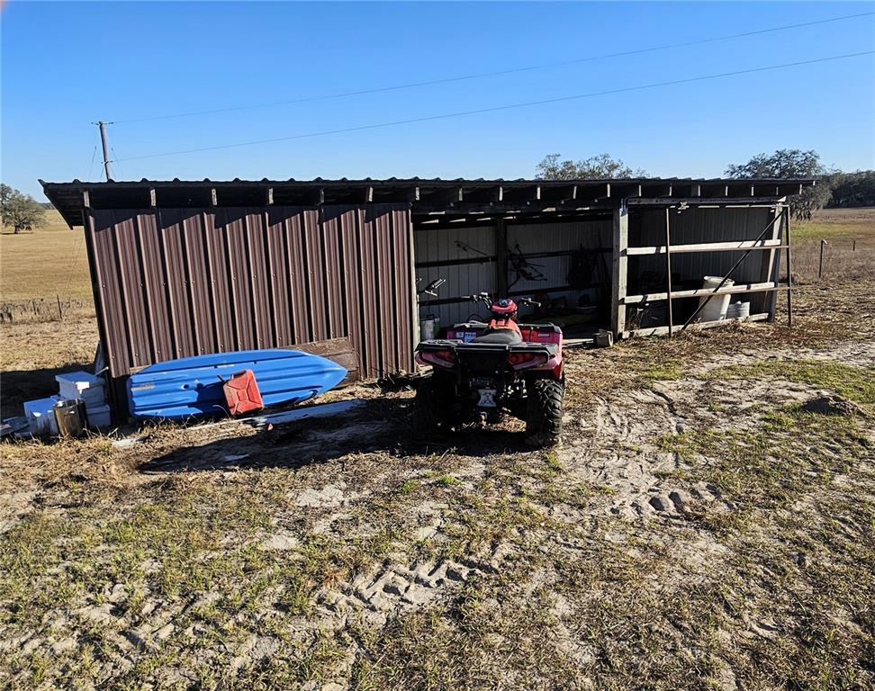 13308 Duck Lake Canal Road Dade City, FL 33525 - Photo 28 of 90 a backyard of a house with barbeque oven table and chairs