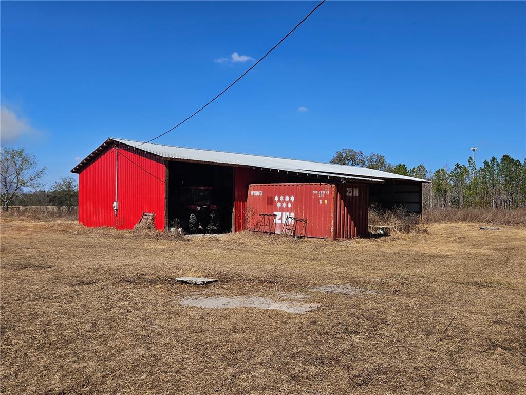 13308 Duck Lake Canal Road Dade City, FL 33525 - Photo 29 of 90 a front view of a house with a yard and garage
