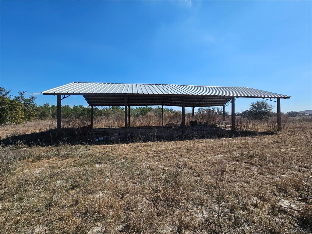 13308 Duck Lake Canal Road Dade City, FL 33525 - Photo 32 of 90 a backyard of a house with table and chairs