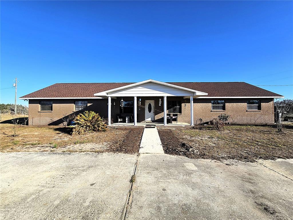 13308 Duck Lake Canal Road Dade City, FL 33525 - Photo 4 of 90 a front view of a house with a yard