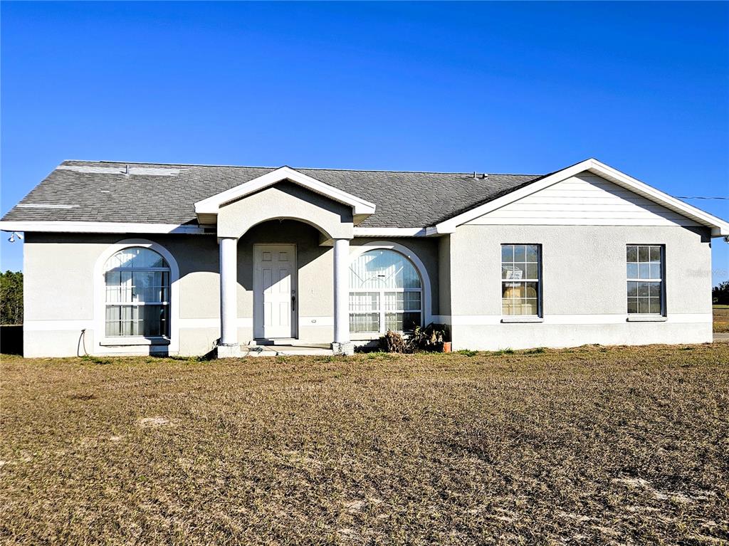 13308 Duck Lake Canal Road Dade City, FL 33525 - Photo 5 of 90 a front view of a house with a yard