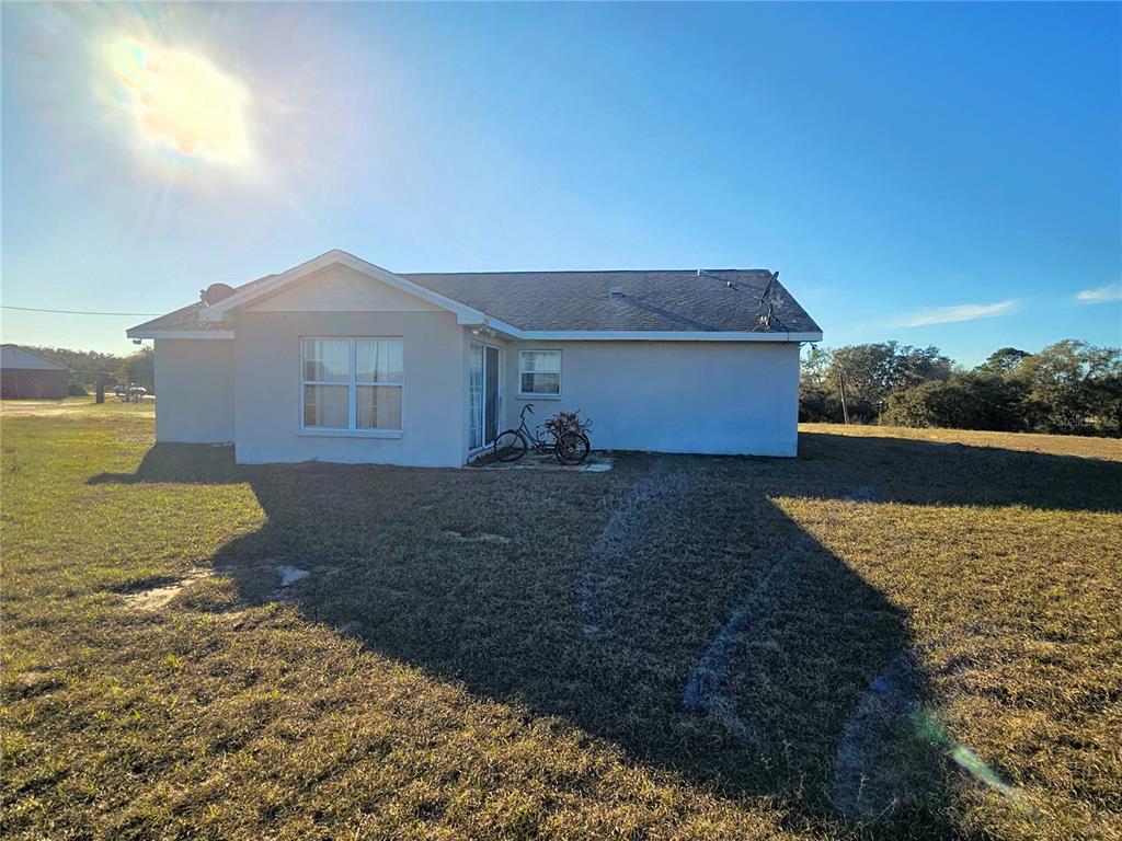 13308 Duck Lake Canal Road Dade City, FL 33525 - Photo 6 of 90 a front view of a house with a yard