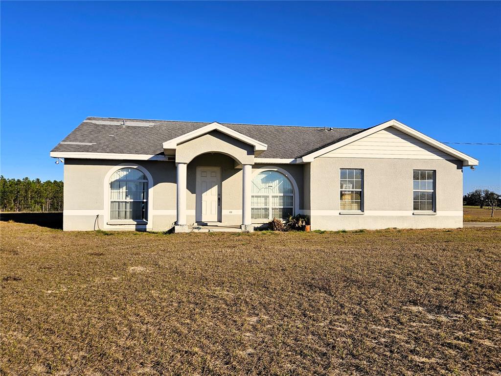 13308 Duck Lake Canal Road Dade City, FL 33525 - Photo 7 of 90 a front view of a house with a yard