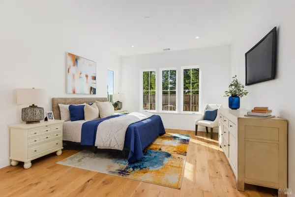 a spacious bedroom with a bed and large windows