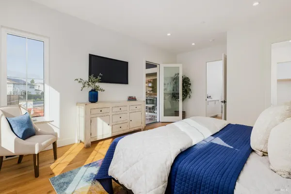 a bedroom with a bed and a flat screen tv