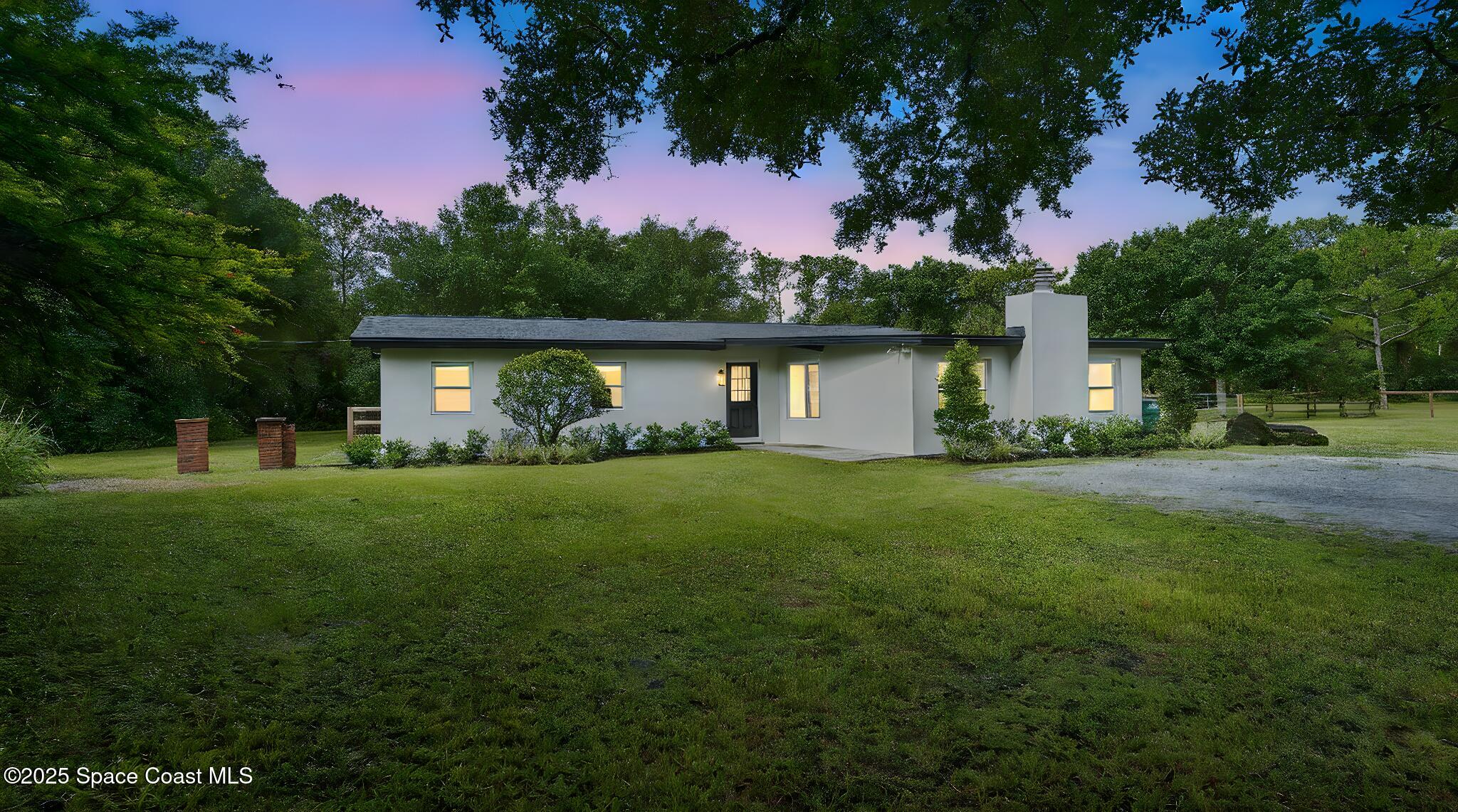 985 Hall Road Malabar, FL 32950 - Photo 1 of 39 a front view of a house with garden