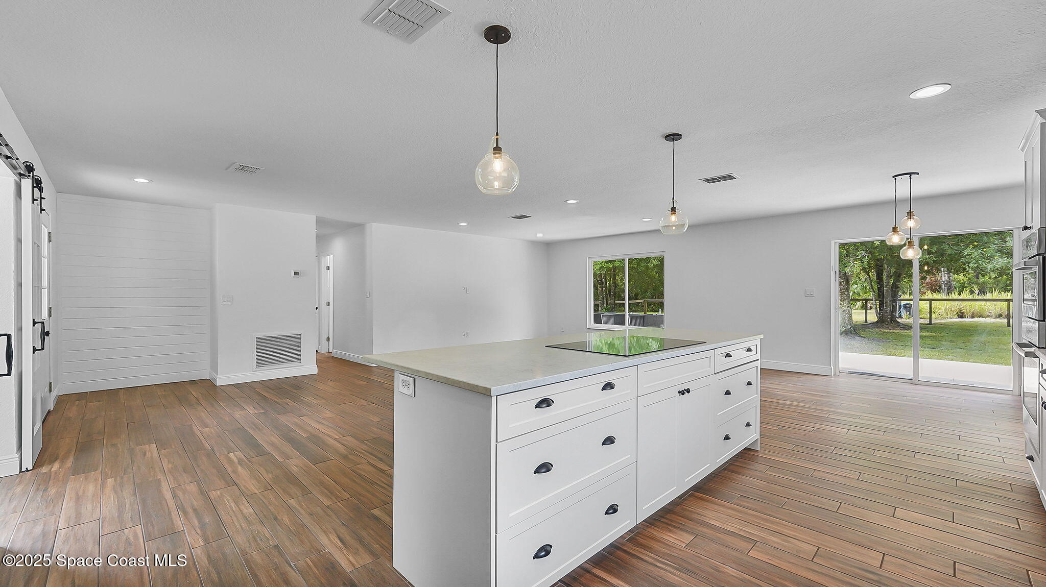 985 Hall Road Malabar, FL 32950 - Photo 11 of 39 a kitchen with granite countertop a stove and a wooden floor