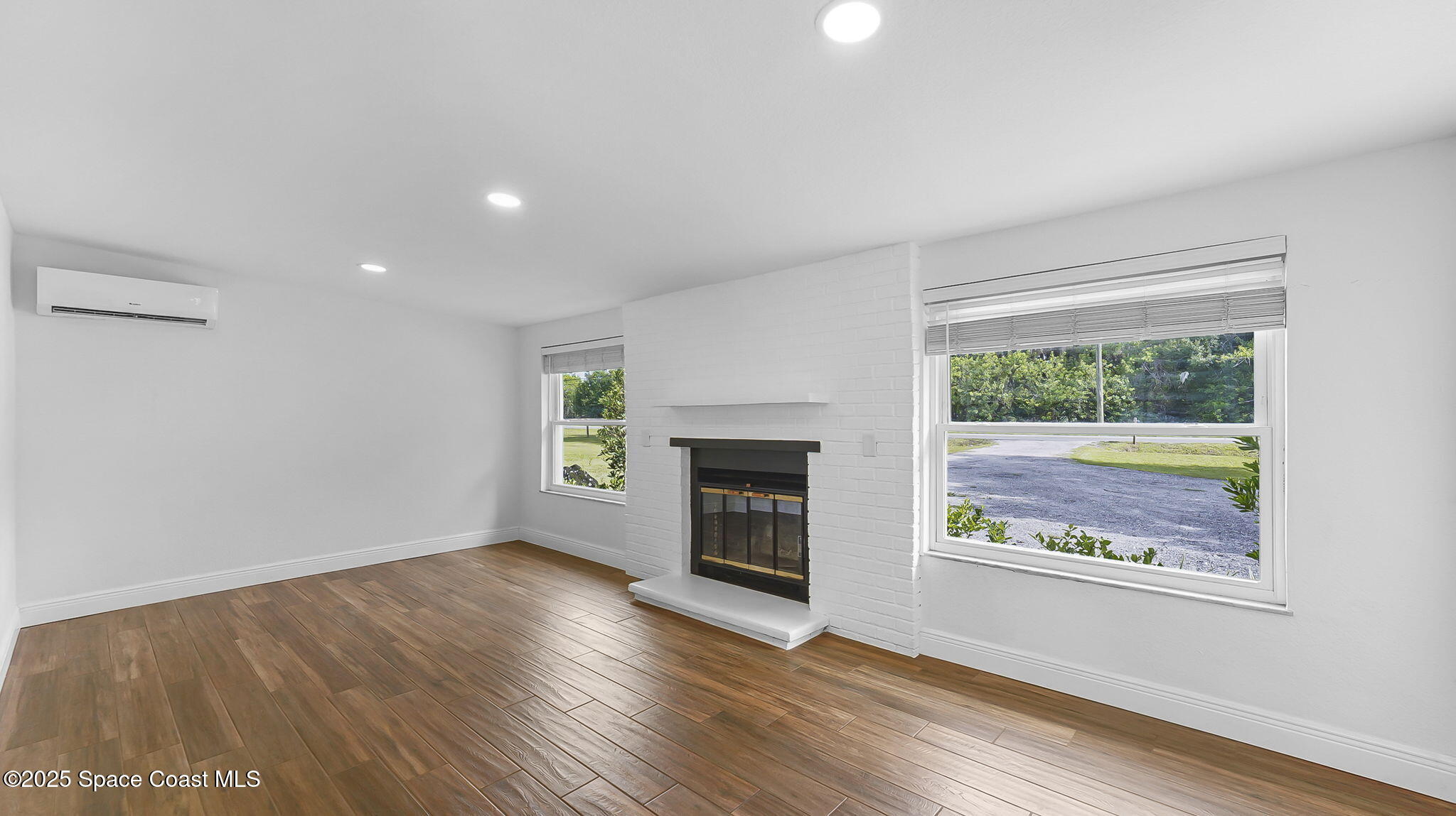 985 Hall Road Malabar, FL 32950 - Photo 19 of 39 wooden floor in an empty room with a window
