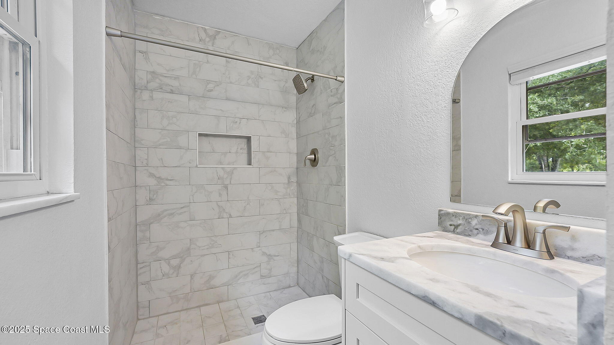 985 Hall Road Malabar, FL 32950 - Photo 25 of 39 a bathroom with a granite countertop sink toilet and shower