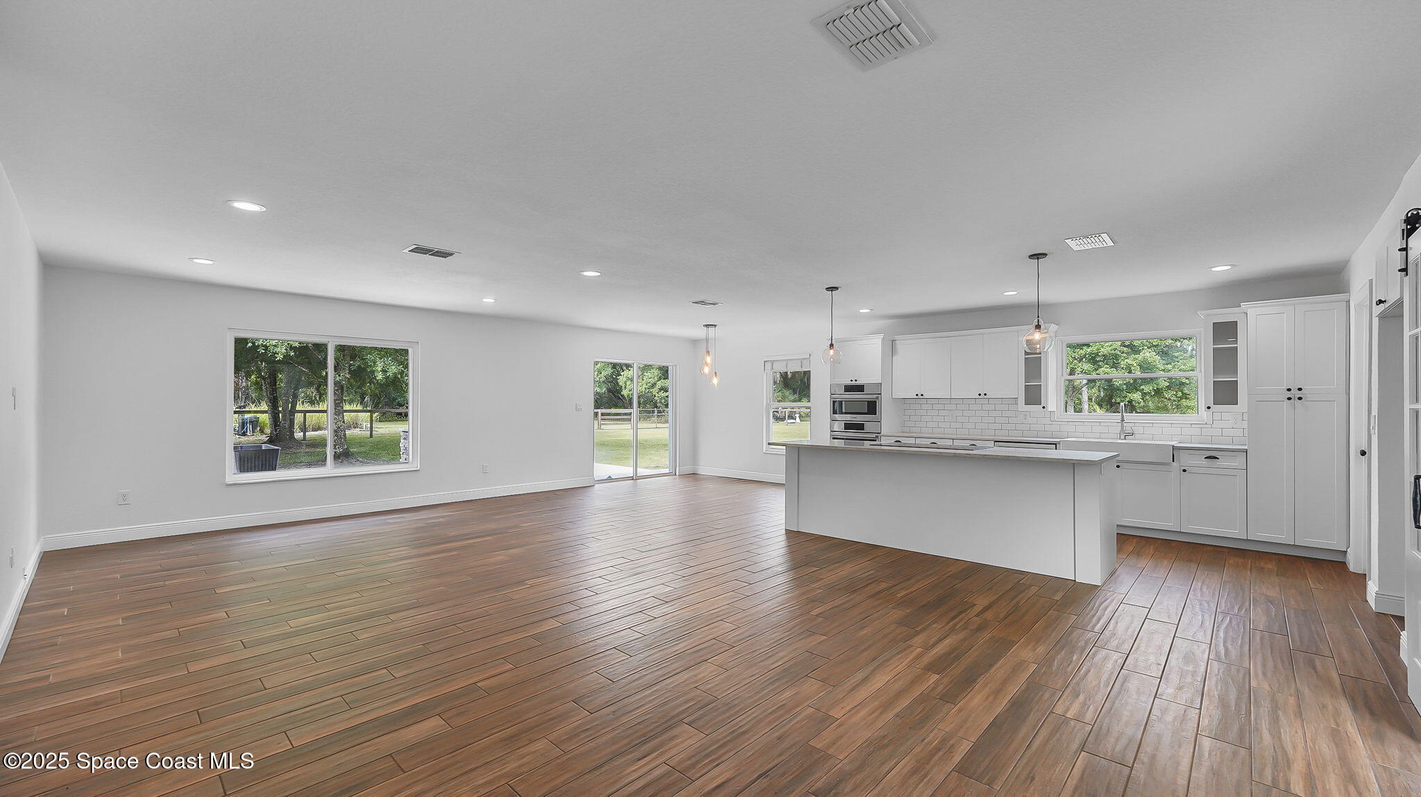 985 Hall Road Malabar, FL 32950 - Photo 4 of 39 a view of kitchen with wooden floor and electronic appliances