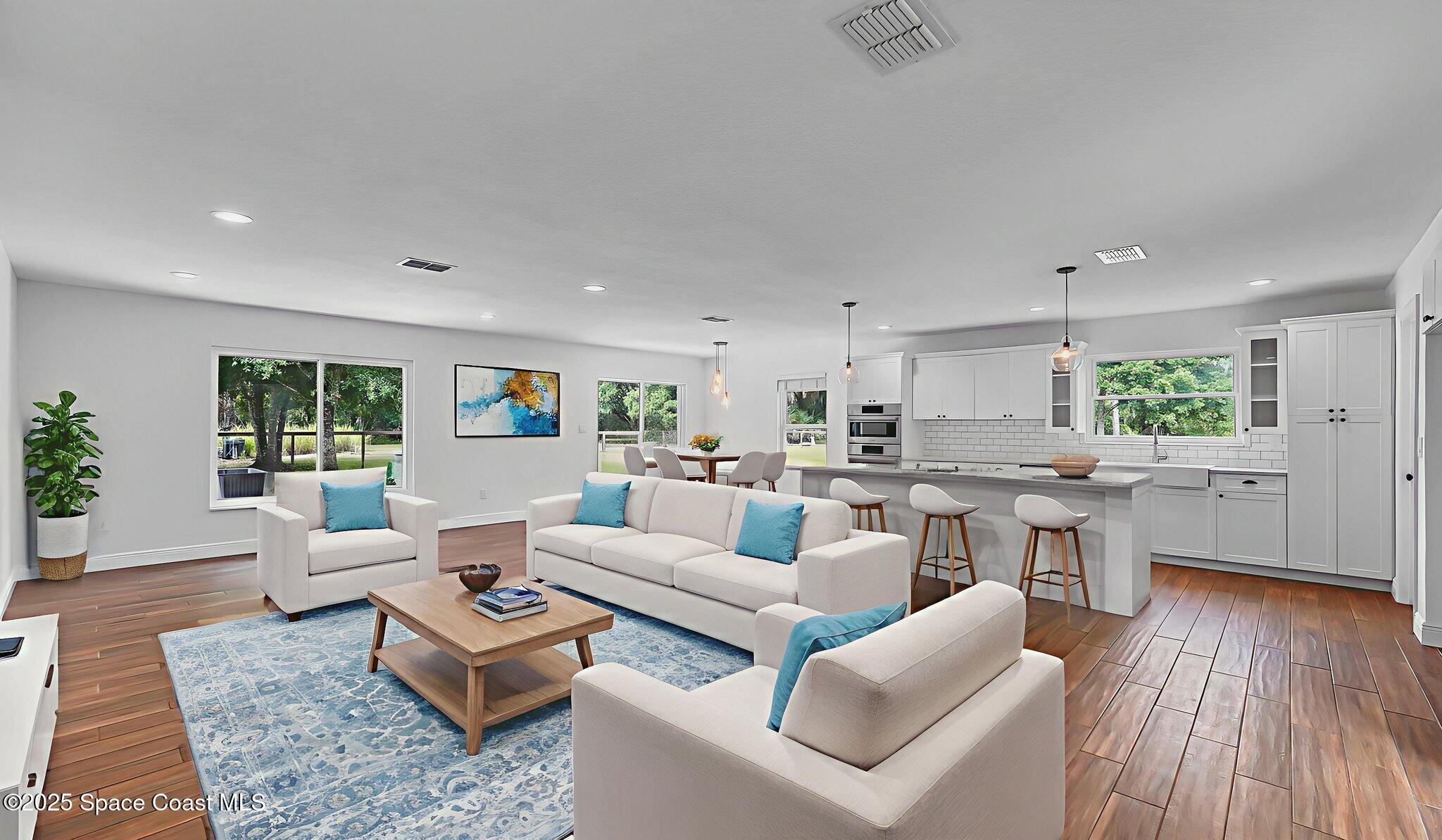 985 Hall Road Malabar, FL 32950 - Photo 5 of 39 a living room with lots of furniture and kitchen view