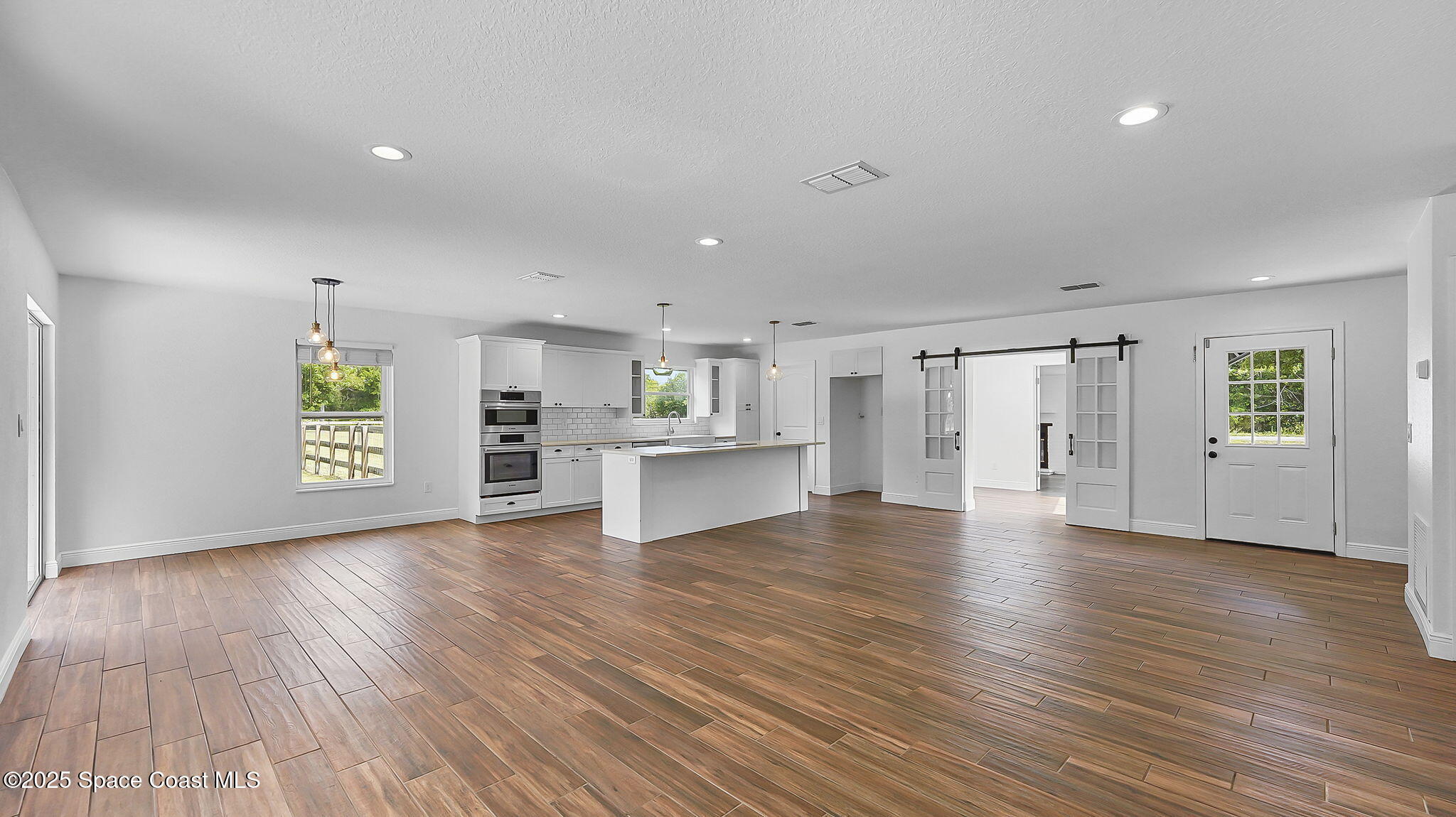 985 Hall Road Malabar, FL 32950 - Photo 6 of 39 a view of an empty room with window and wooden floor