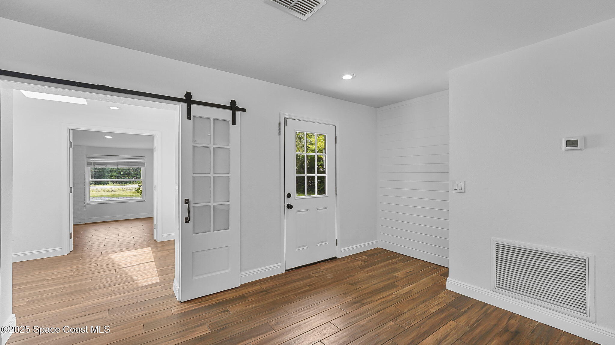 985 Hall Road Malabar, FL 32950 - Photo 7 of 39 a view of empty room with wooden floor and fan