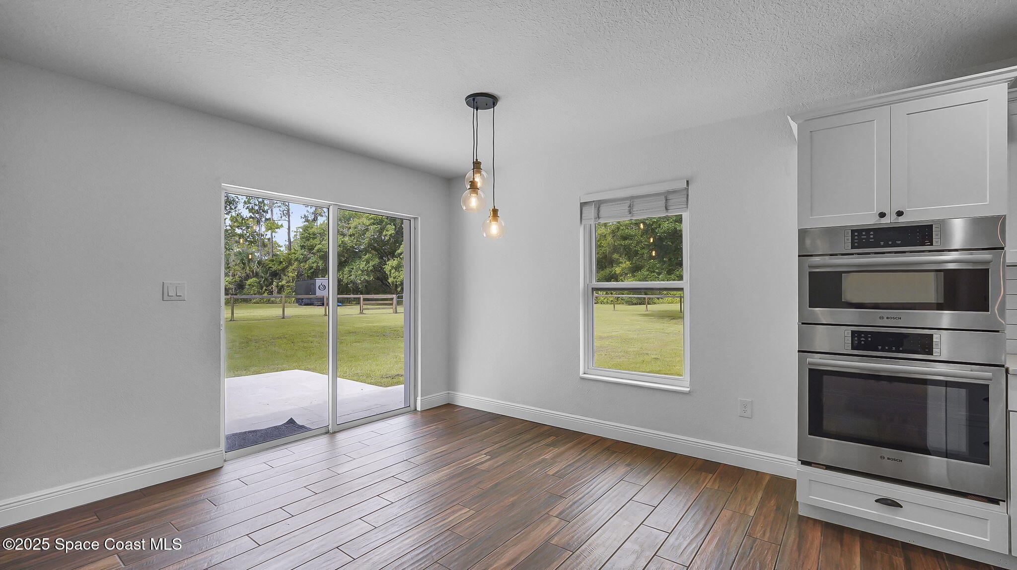 985 Hall Road Malabar, FL 32950 - Photo 8 of 39 a view of an empty room with a window and wooden floor