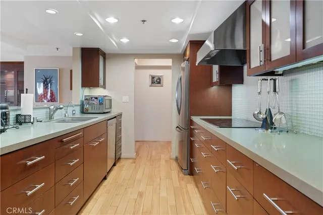 a kitchen with stainless steel appliances granite countertop a sink stove and cabinets