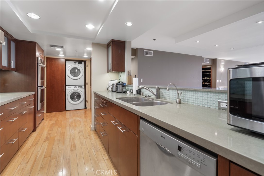 10660 Wilshire Boulevard, Unit 609 Los Angeles, CA 90024 - Photo 5 of 20 a large kitchen with stainless steel appliances a large counter top